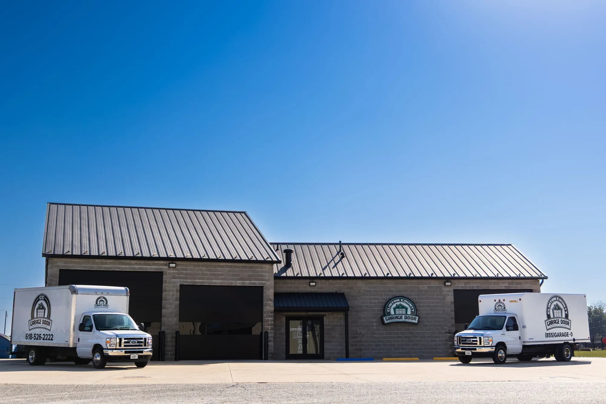 CC Garage Door shop in Aviston with two lettered box trucks parked out front