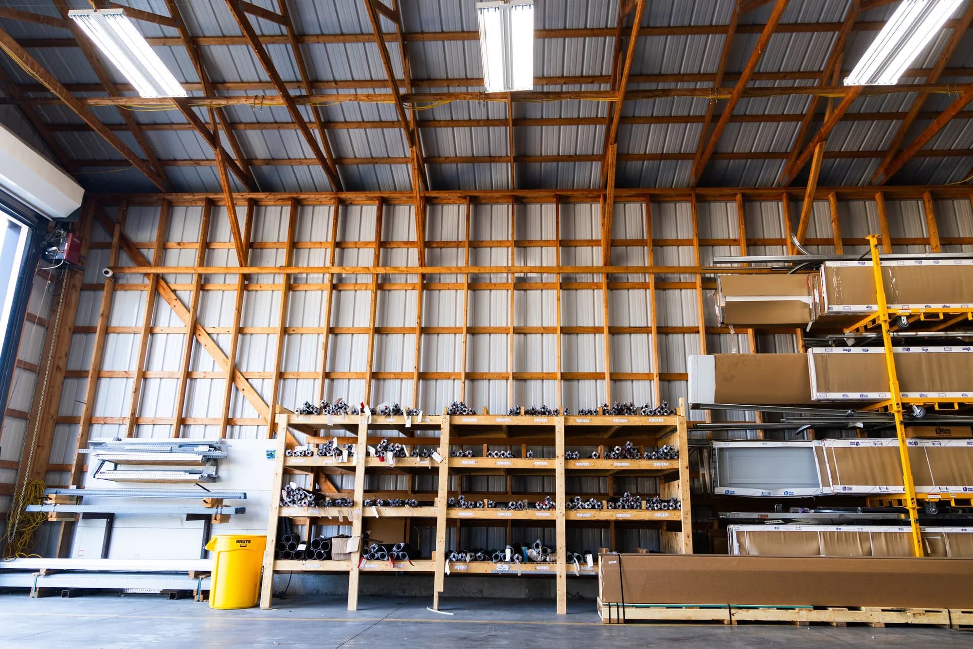 Racks of garage door springs and hardware inside the CC Garage Door warehouse